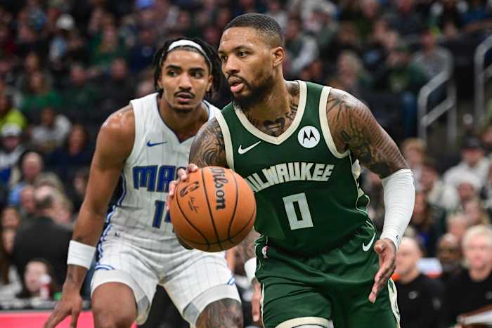 Milwaukee Bucks guard Damian Lillard (0) drives past Orlando Magic guard Gary Harris (14)